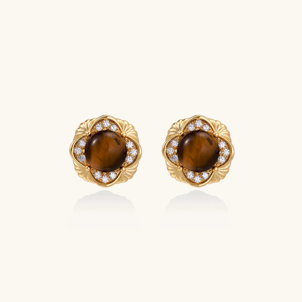 Gold-plated stud earrings with ornate floral frames surrounding cabochon tiger's eye stones and zirconia accents