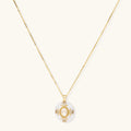 Gold-plated necklace with circular white enamel pendant featuring central zirconia stone and ornate decorative details