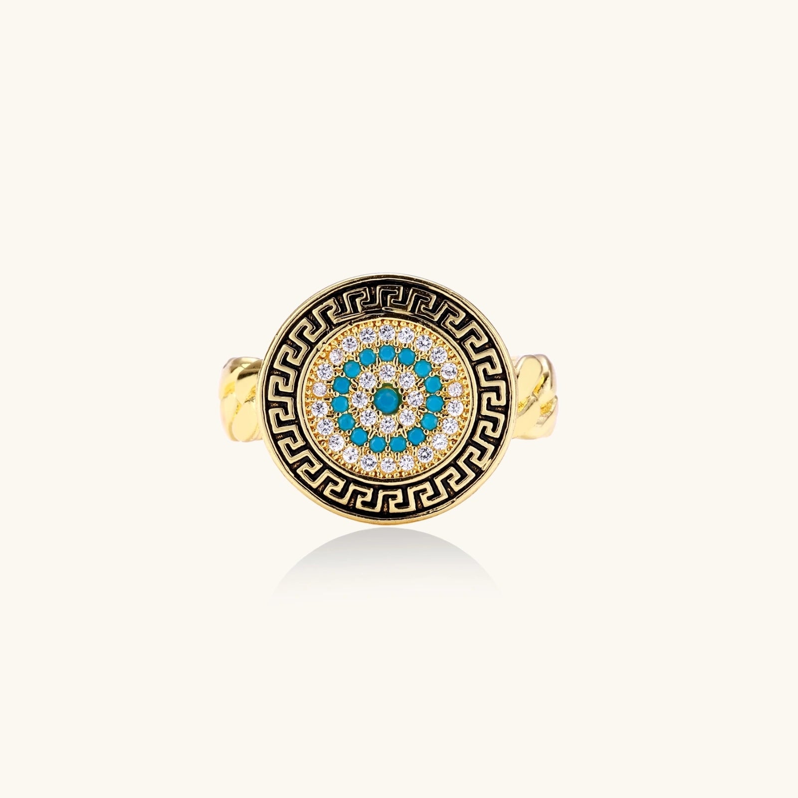 Gold chain ring with Greek key border and turquoise evil eye center on white background